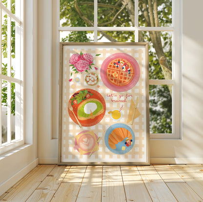 Framed artwork with brunch food illustrations in a bright room with large windows.