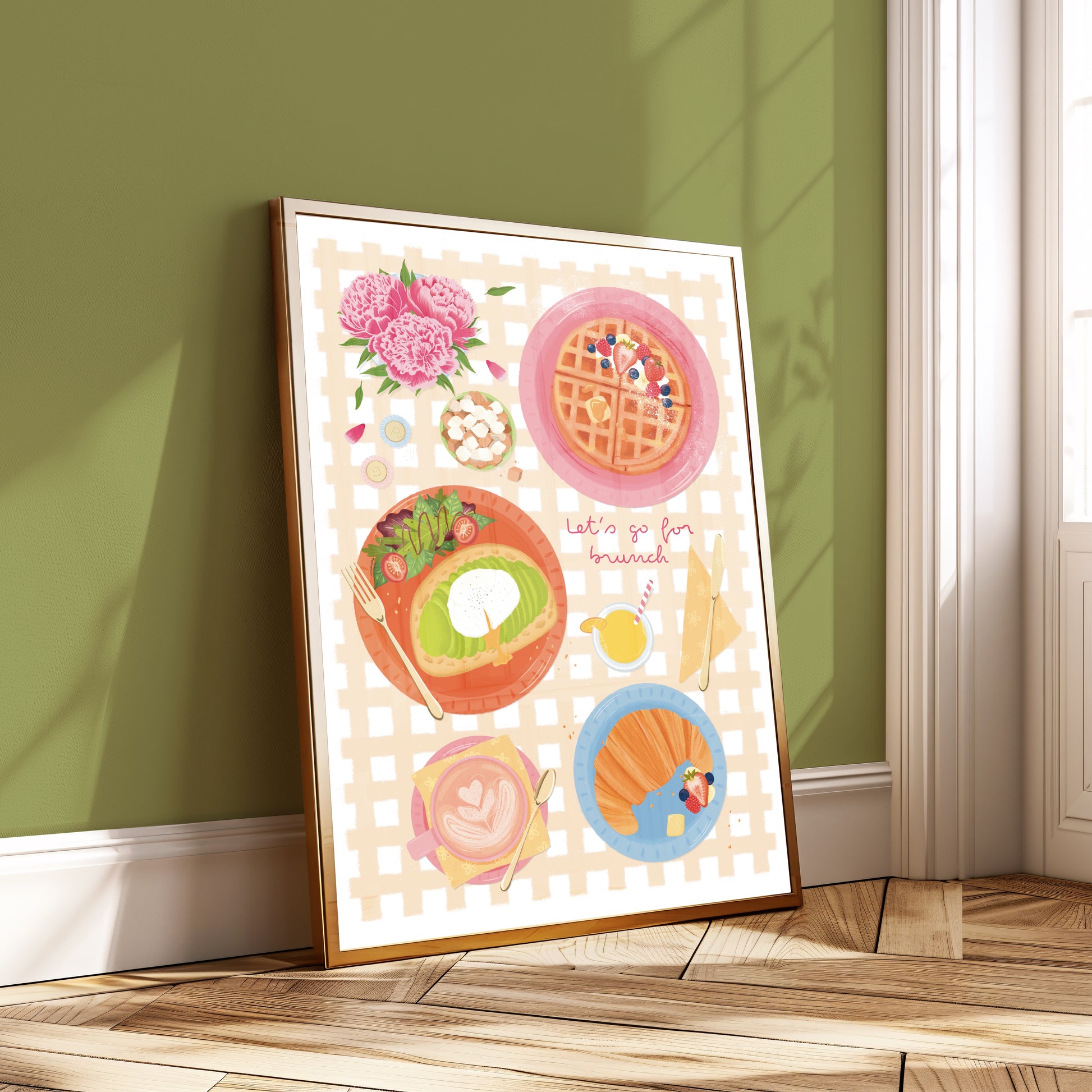 Framed artwork of illustrated brunch items on a wall with green paint.