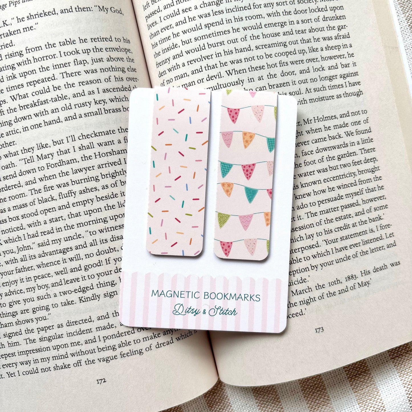 Magnetic bookmarks with colourful bunting and sprinkles designs on an open book