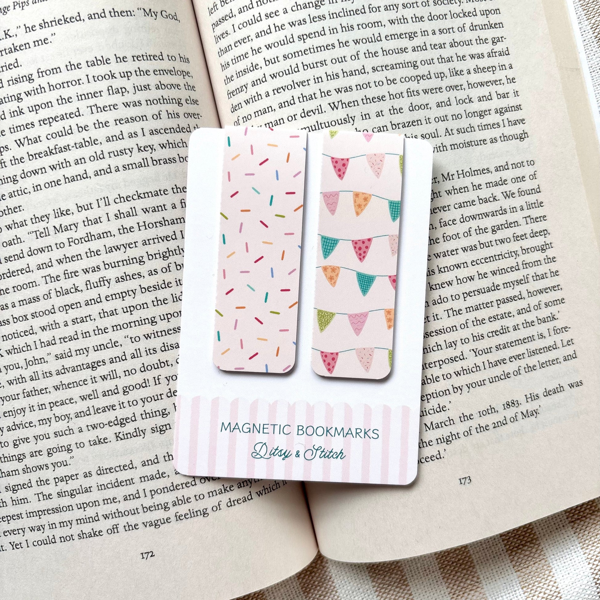 Magnetic bookmarks with colourful bunting and sprinkles designs on an open book