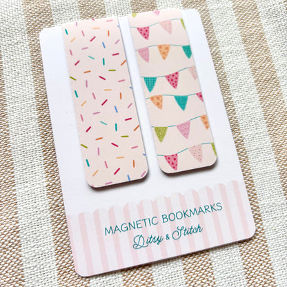 Two magnetic bookmarks with colourful bunting and sprinkles designs on a striped fabric background