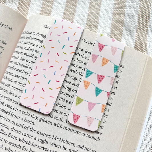 Two patterned bookmarks on an open book with a striped background