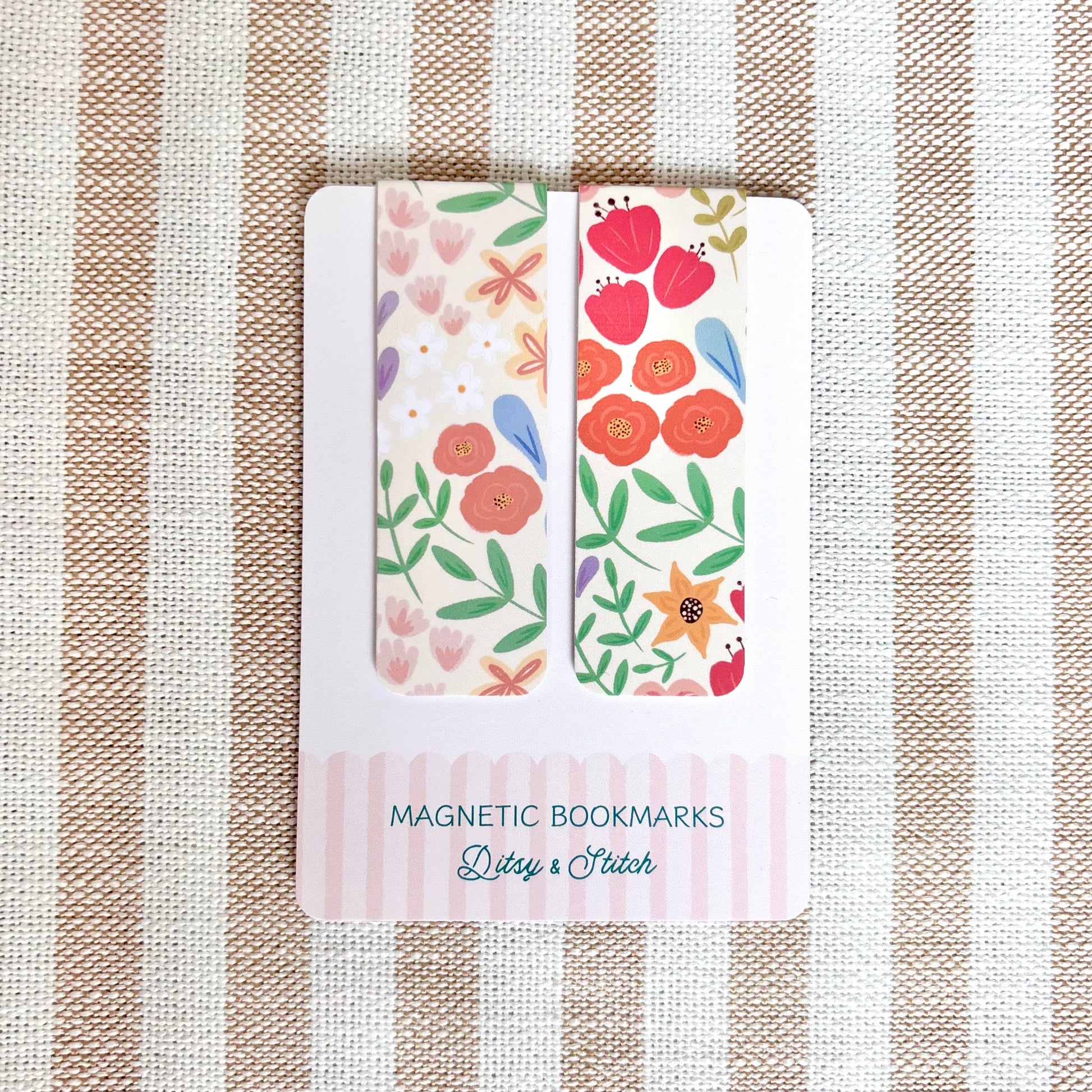Pack of magnetic bookmarks with floral design on a striped fabric background