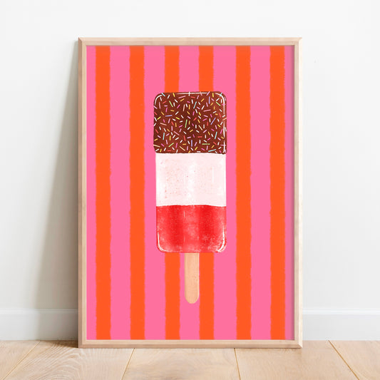 A framed art print featuring a hand-drawn popsicle with a brown chocolate-coated top and sprinkles, set against a background of vertical pink and orange stripes, leaning against a white wall on a light wood floor.