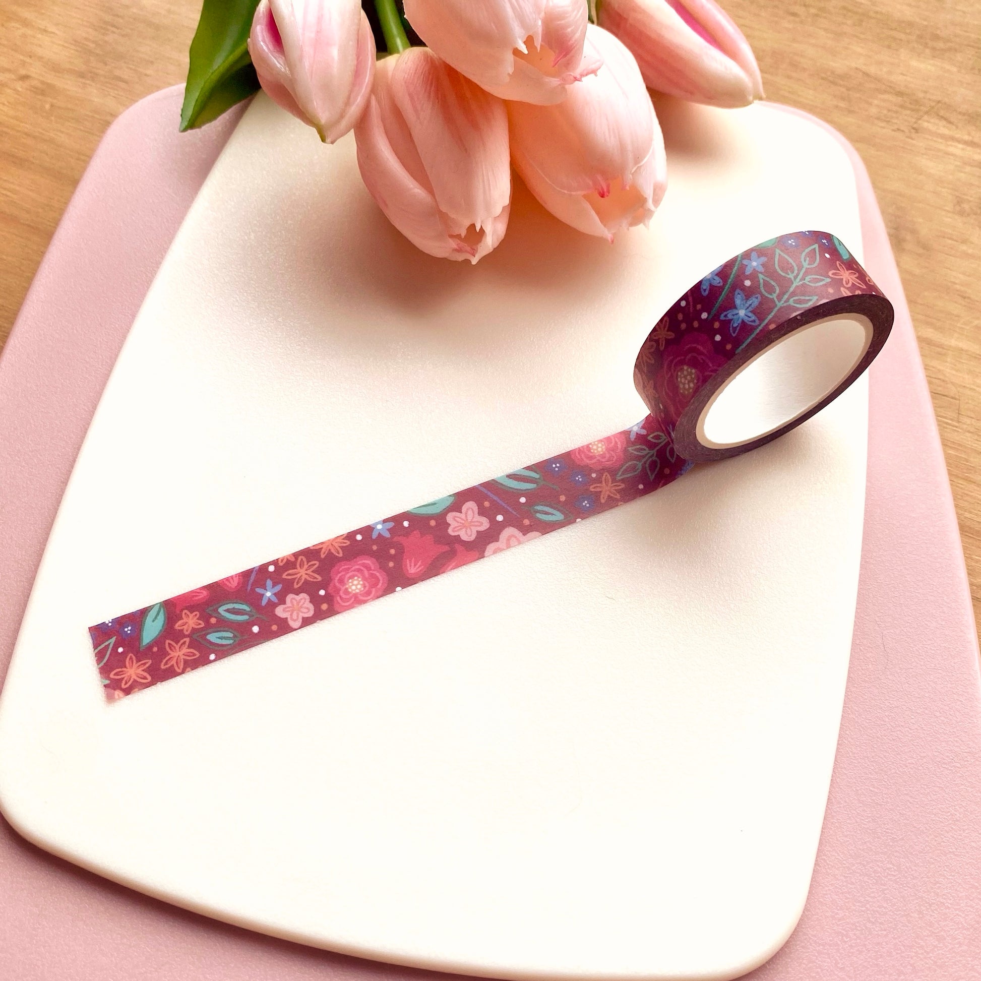 Decorative tape with floral pattern on a pink surface with tulips