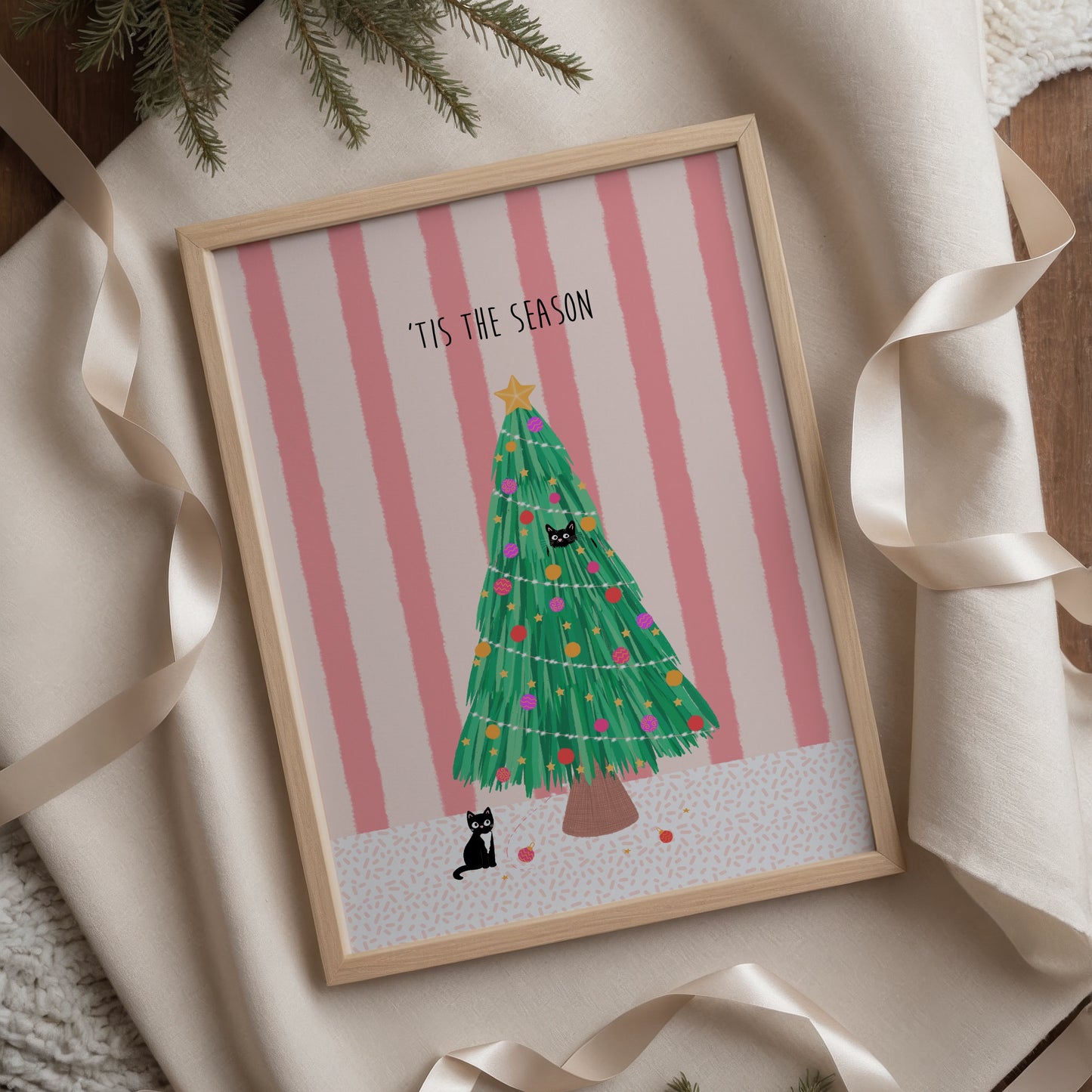 Framed Christmas-themed artwork with a tree and text on a striped background