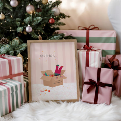 Framed Christmas-themed print with presents and a decorated tree in the background