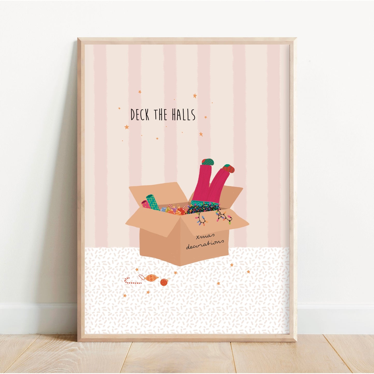 Framed artwork with a cardboard box and legs peeking out, on a light pink background.