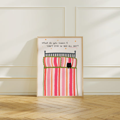 Framed artwork with a cartoon of a cat in bed and text on a white wall.