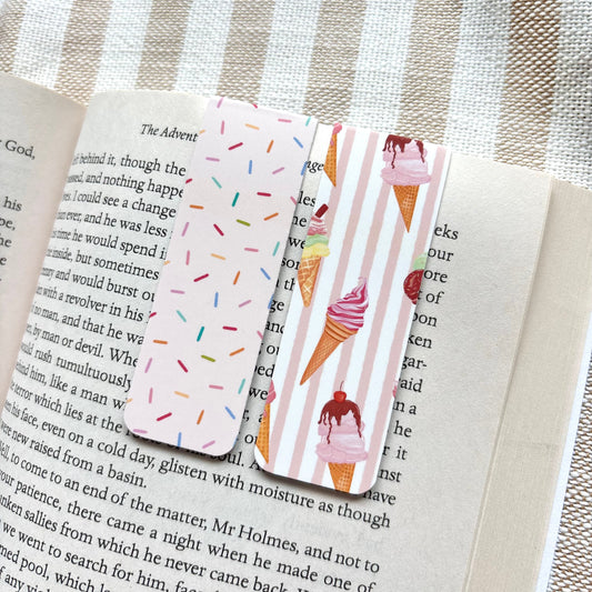 Two colourful magnetic bookmarks with ice cream and sprinkles designs on an open book.