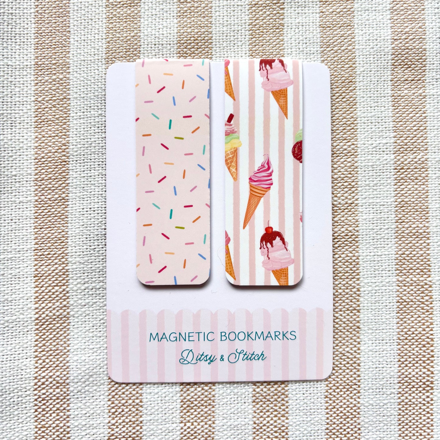 Two magnetic bookmarks with ice cream and sprinkles designs on a striped fabric background