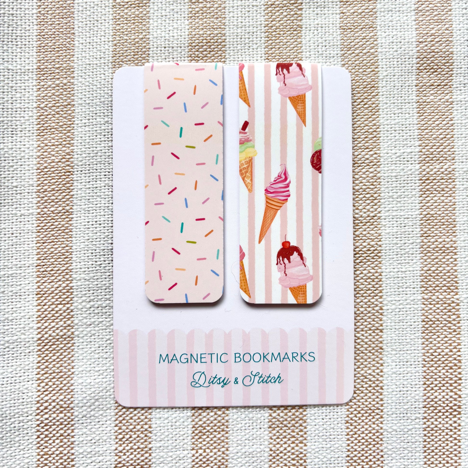 Two magnetic bookmarks with ice cream and sprinkles designs on a striped fabric background