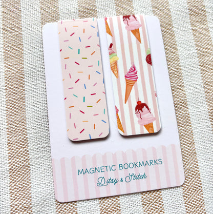 Two magnetic bookmarks with ice cream cone and sprinkles designs on a striped fabric background