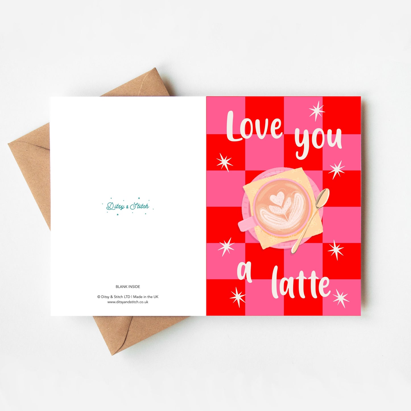 Greeting card with 'Love you a latte' text and coffee design on a red and pink checkered background, with a brown envelope.
