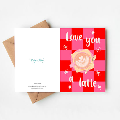 Greeting card with 'Love you a latte' text and coffee design on a red and pink checkered background, with a brown envelope.
