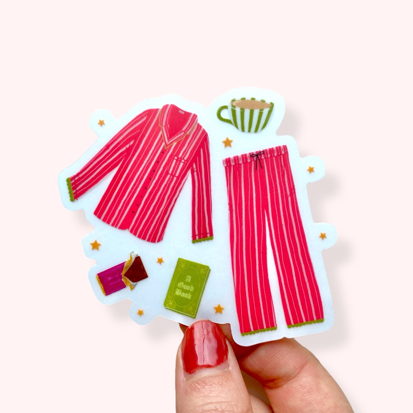 Sticker with pink striped pyjamas, green book, and cup held by a hand on a white background