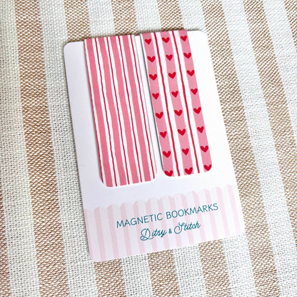 Pack of magnetic bookmarks with heart and striped patterns on a striped fabric background