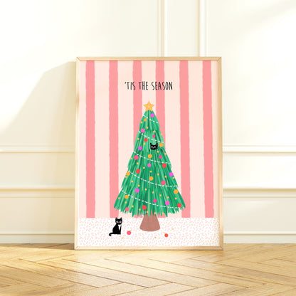 Framed artwork with a Christmas tree, 2 black cats and 'Tis the Season text on a pink striped background.