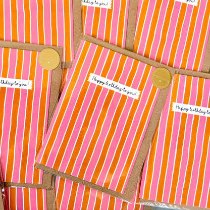 Pink and orange striped cards with 'Happy birthday to you!' text and gold Ditsy & Stitch stickers.