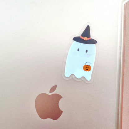Halloween-themed ghost sticker with a witch hat and pumpkin on an Apple tablet.