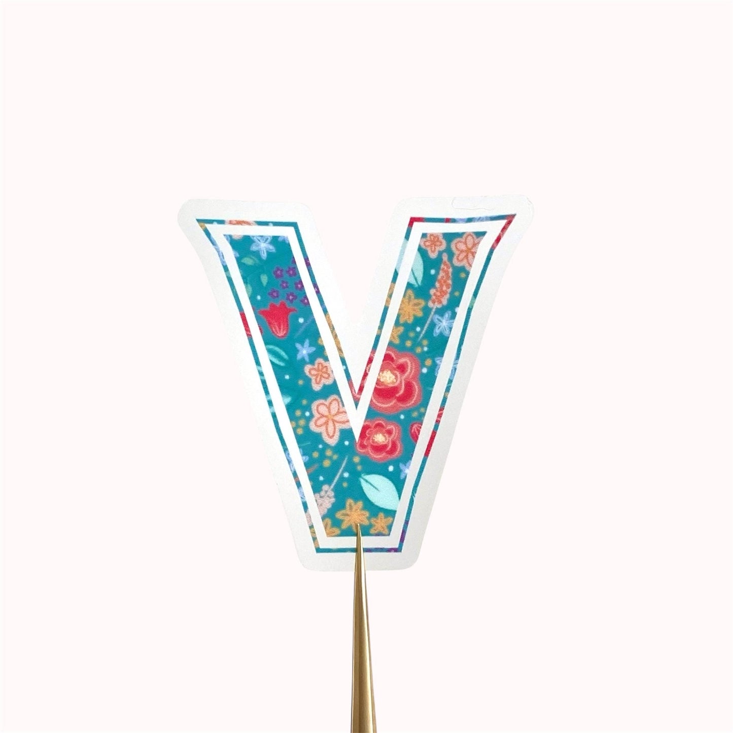 Decorative letter 'V' sticker with floral design on a white background