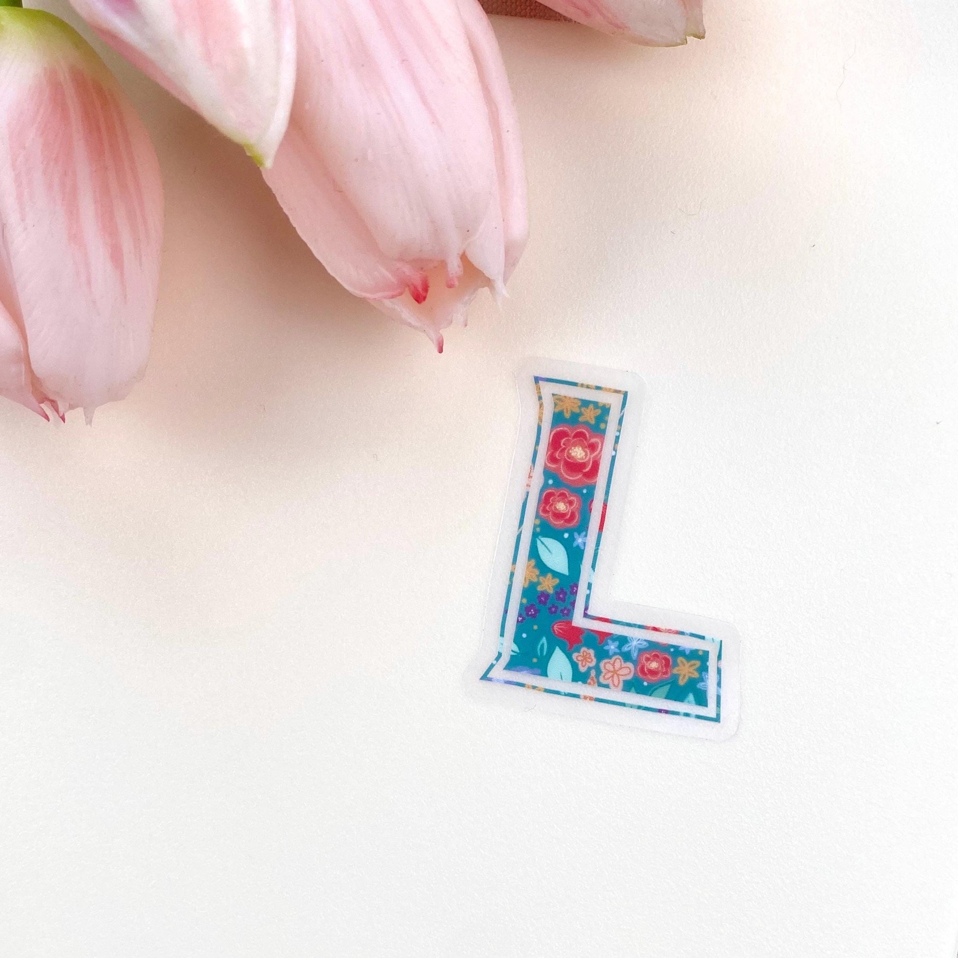 Floral letter 'L' sticker on a white background with pink tulips