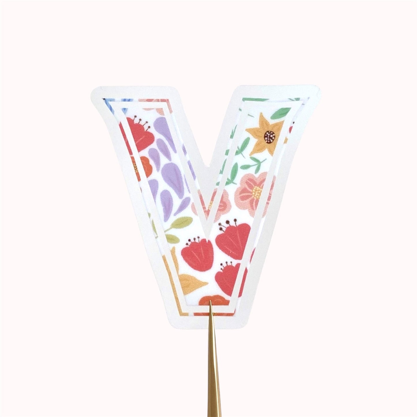 A floral letter 'V' sticker against a white background