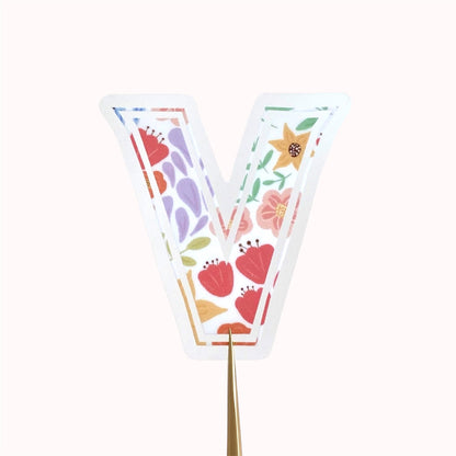 A floral letter 'V' sticker against a white background