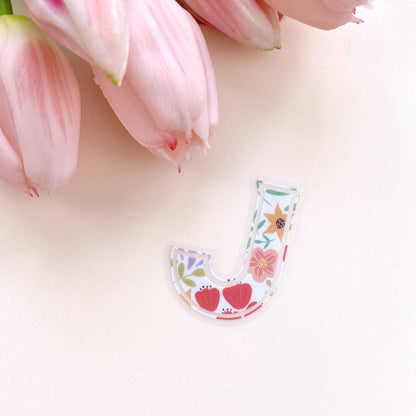 Floral letter 'J' sticker with pink tulips on a light background