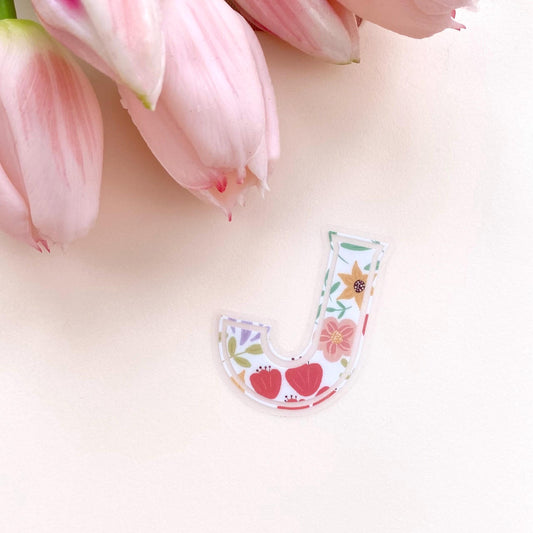 Floral letter 'J' sticker with pink tulips on a light background