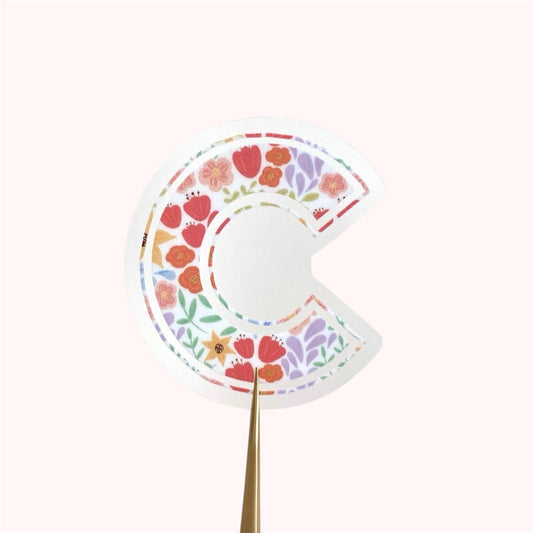 Sticker with letter 'C' with floral pattern on a white background