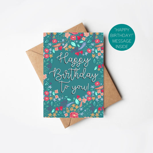 Birthday card with floral design and 'Happy Birthday to you!' text, accompanied by a brown envelope on a white background.