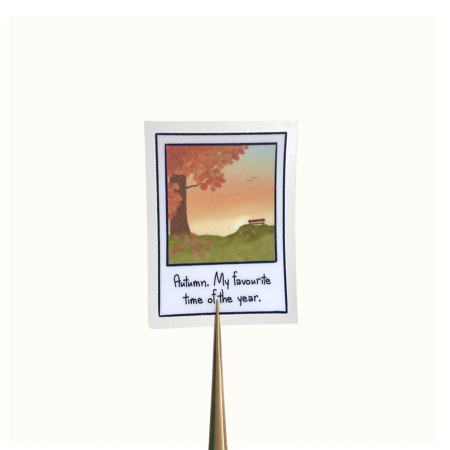 Sticker with autumn scene polaroid  and text on a white background