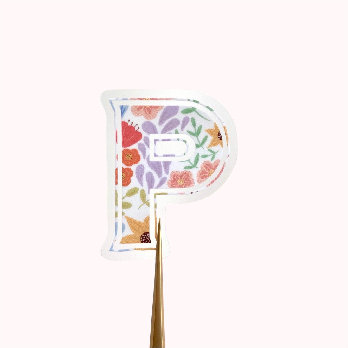 Floral letter 'P' sticker on a cream background.