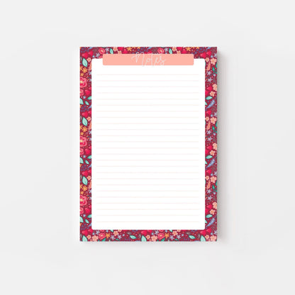 Floral patterned notepad with a pink border on a white background
