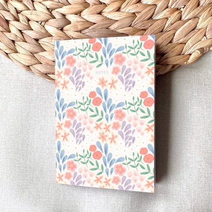 Notebook with floral pattern on a woven mat