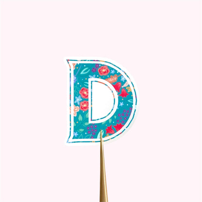 Decorative letter 'D' sticker with floral pattern on a white background