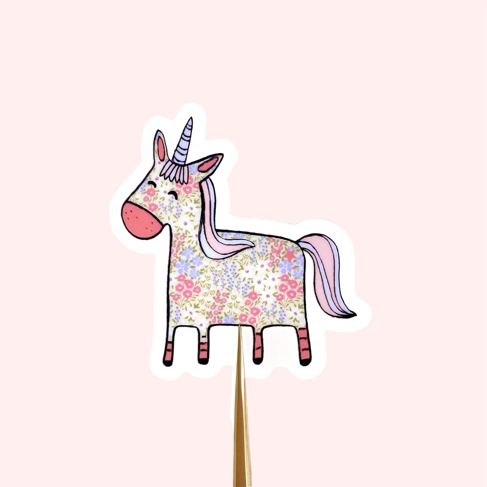 Floral patterned pink and blue unicorn on a transparent vinyl sticker
