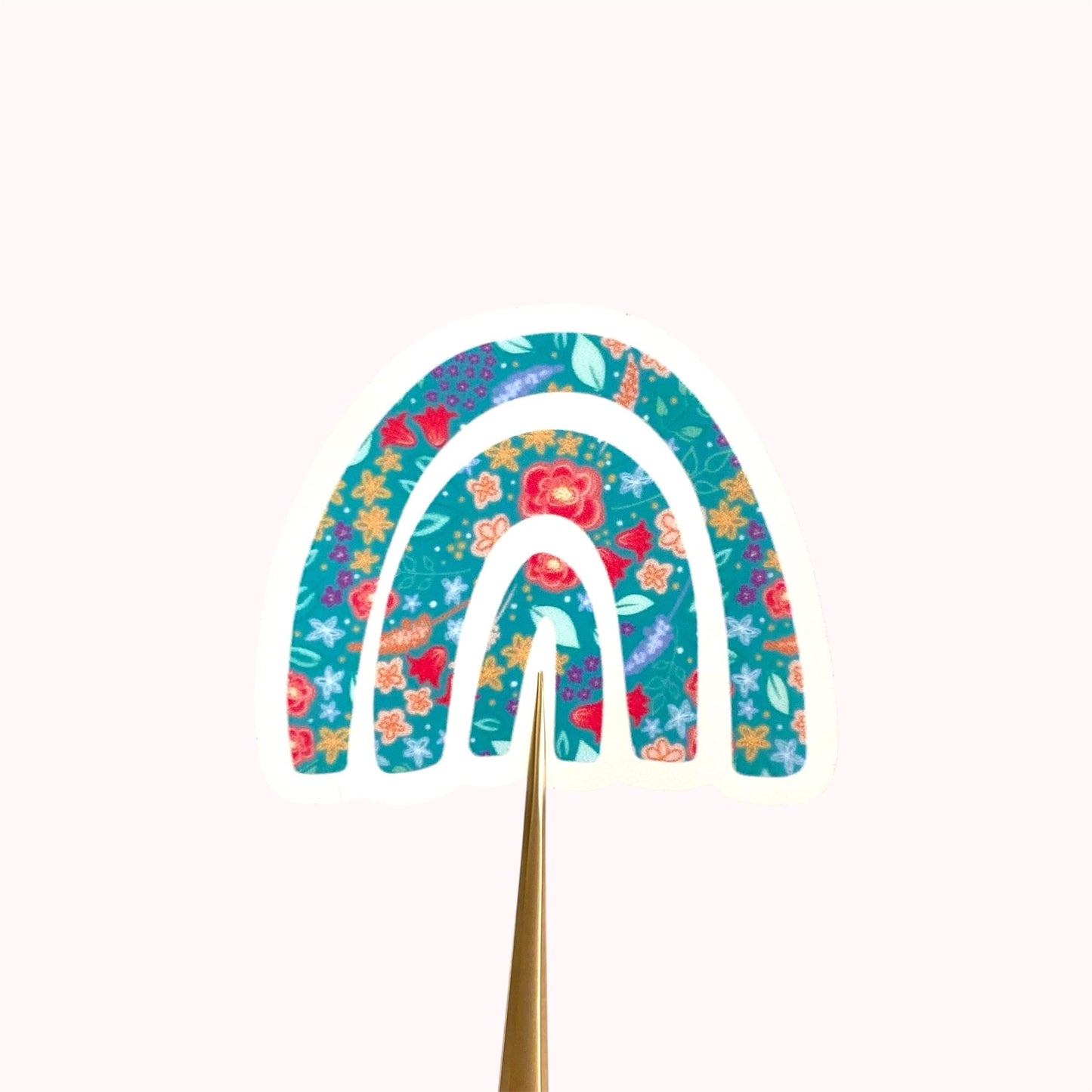 Decorative rainbow sticker with floral patterns on a white background
