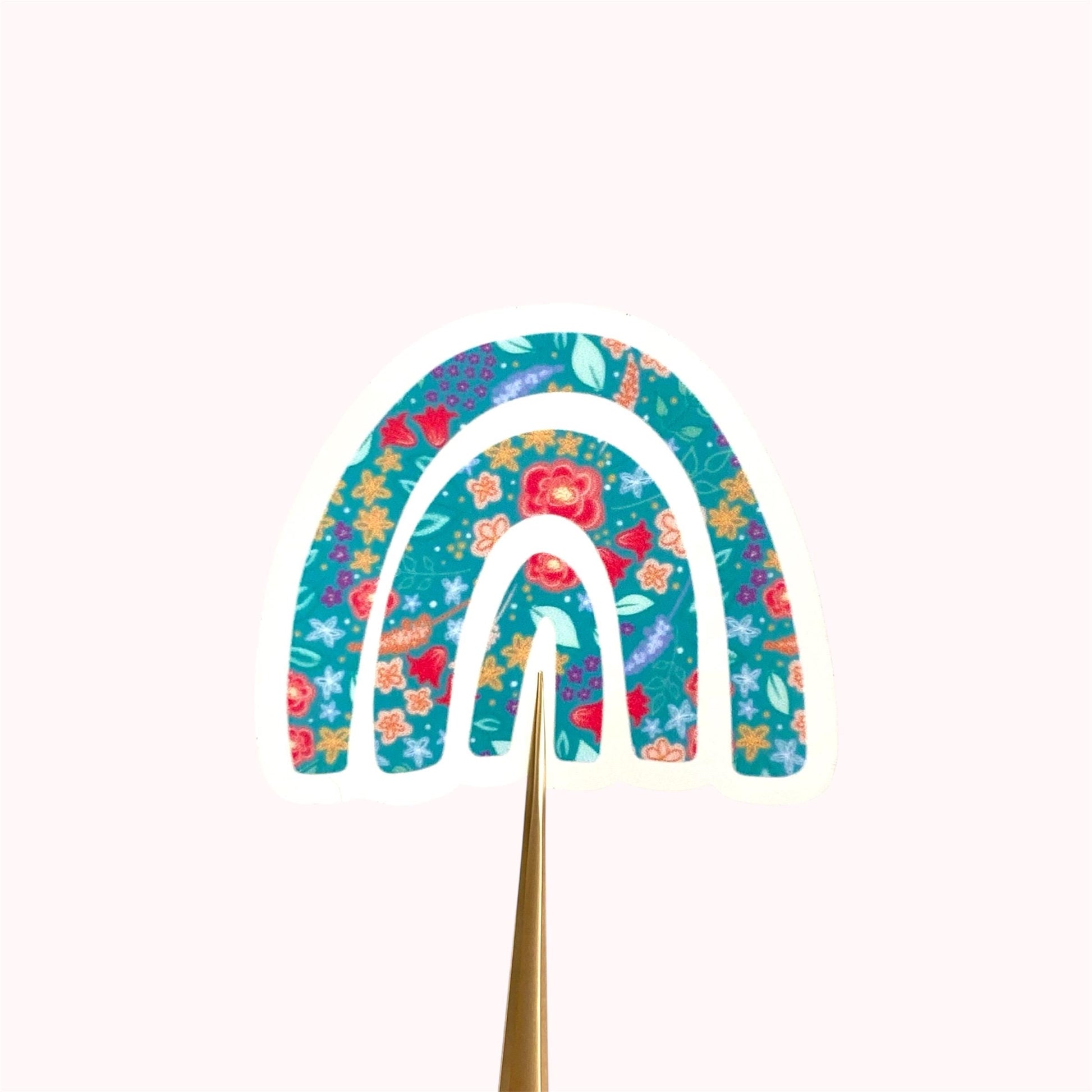 Decorative rainbow sticker with floral patterns on a white background