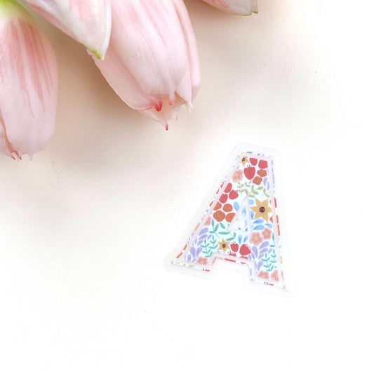 Decorative letter 'A' sticker with floral pattern on a white background
