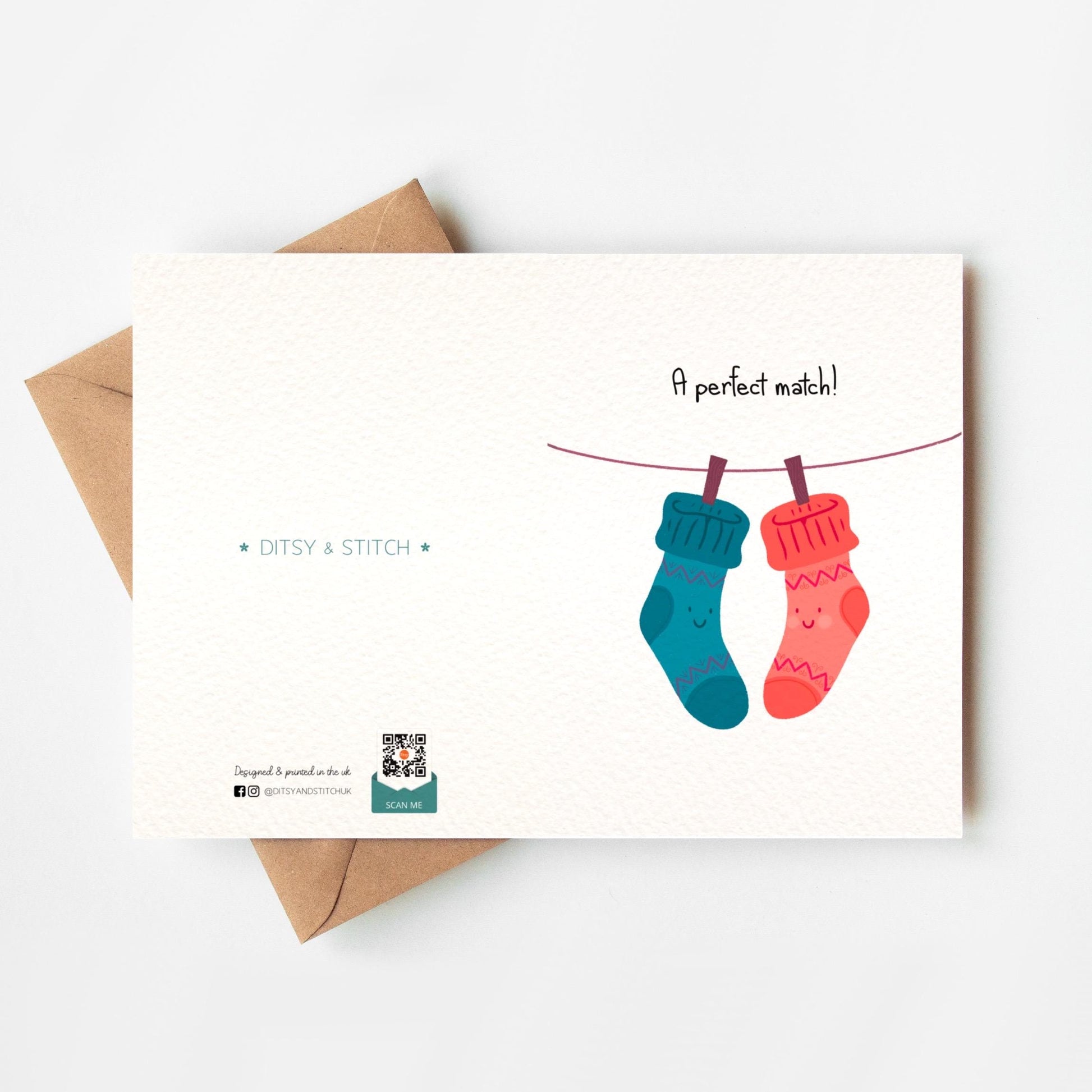 Greeting card with two socks on a line and 'A perfect match!' text, featuring Ditsy & Stitch branding on the back.