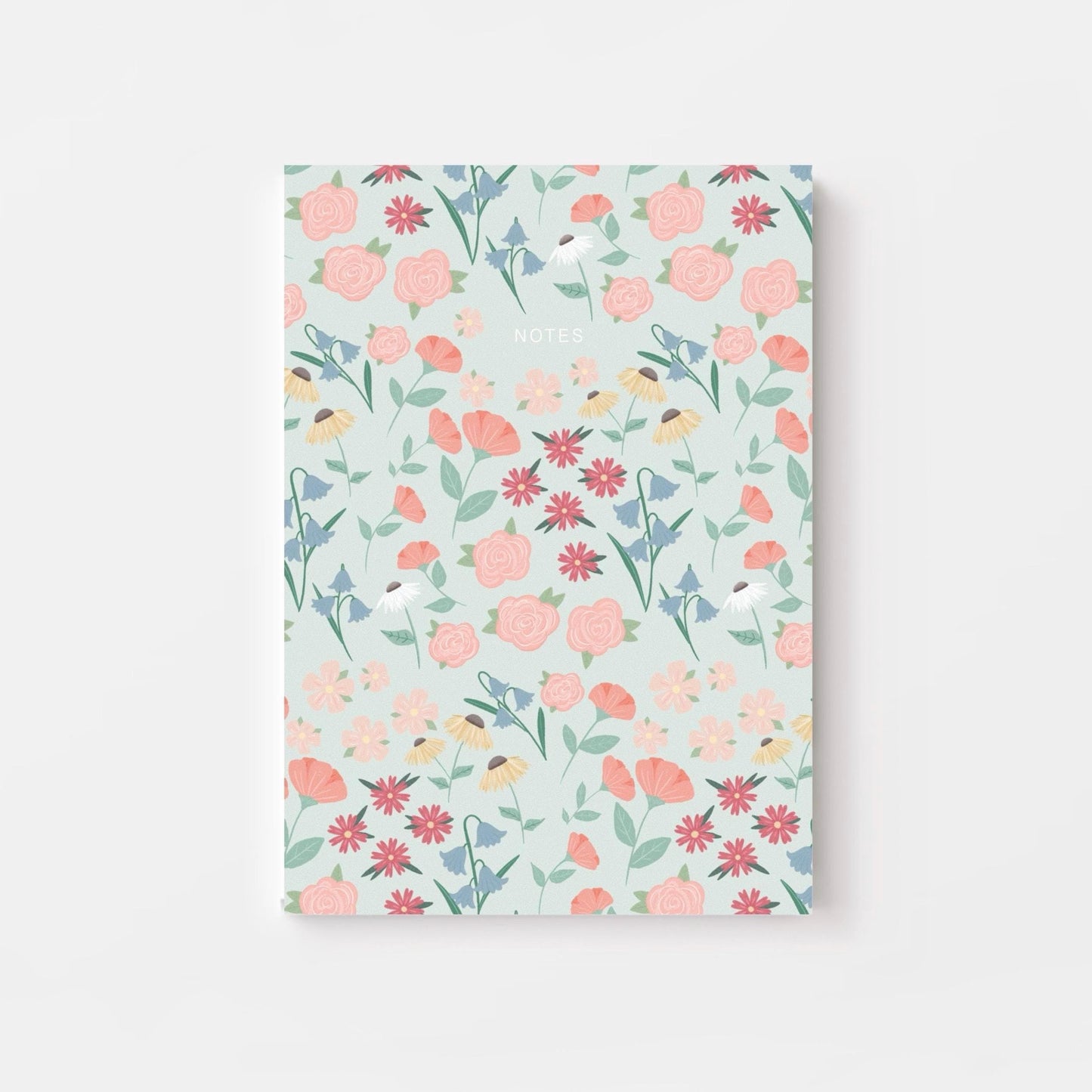 Floral patterned notebook on a light blue background