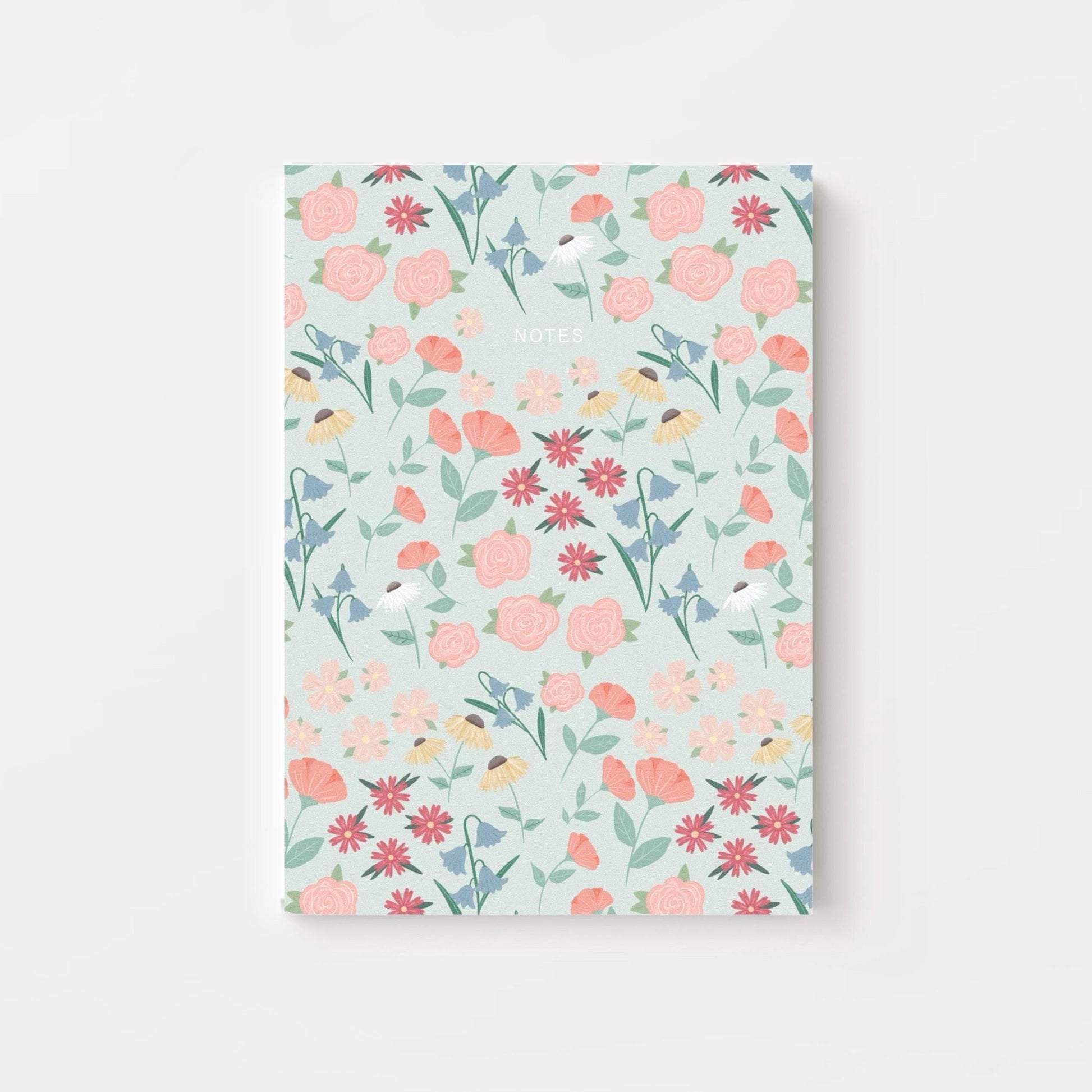 Floral patterned notebook on a light blue background