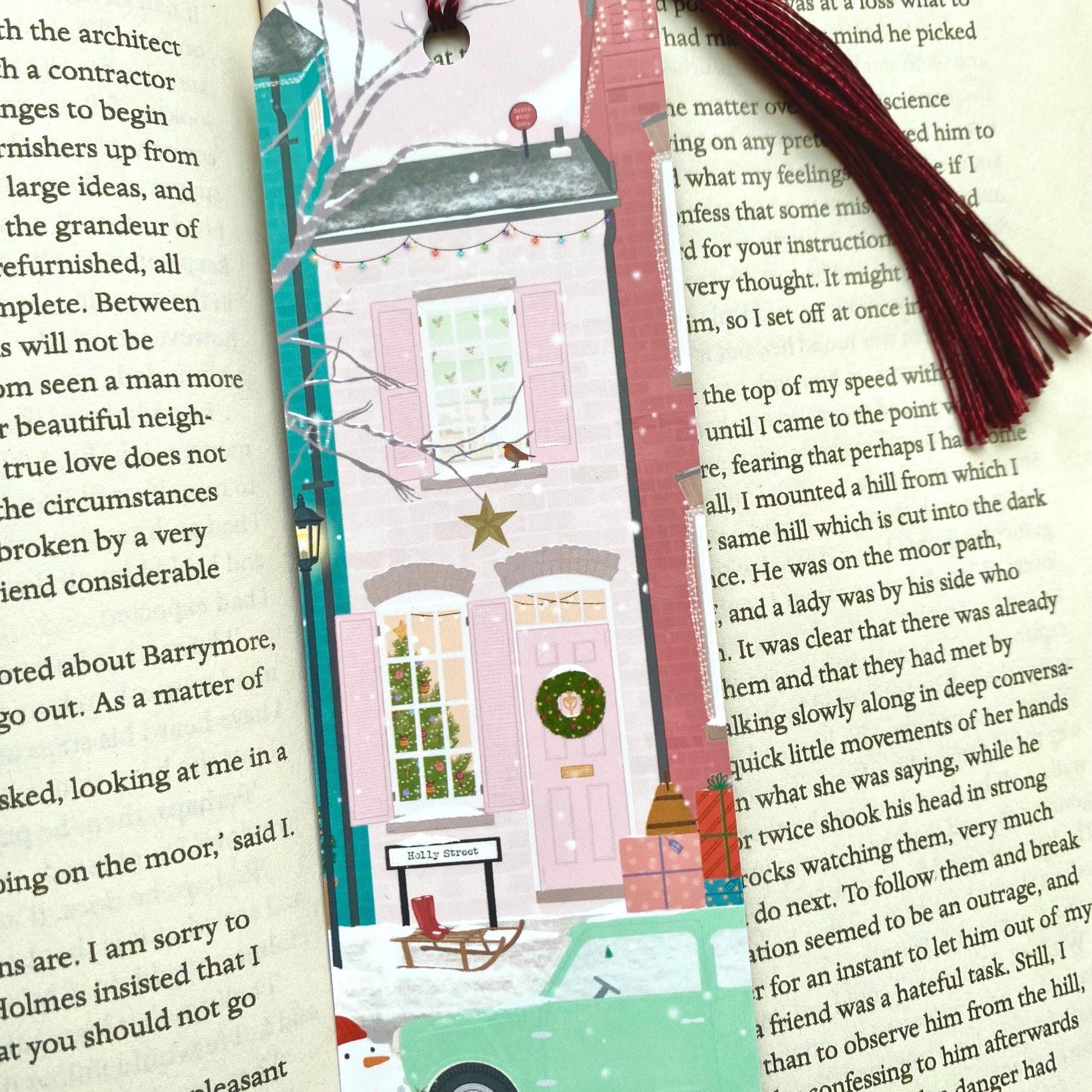 Decorative bookmark with a winter scene on an open book