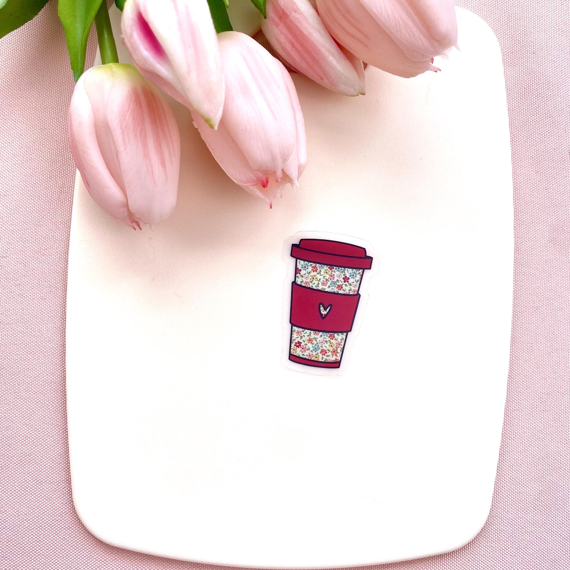 Floral coffee cup sticker on a white plate with pink tulips