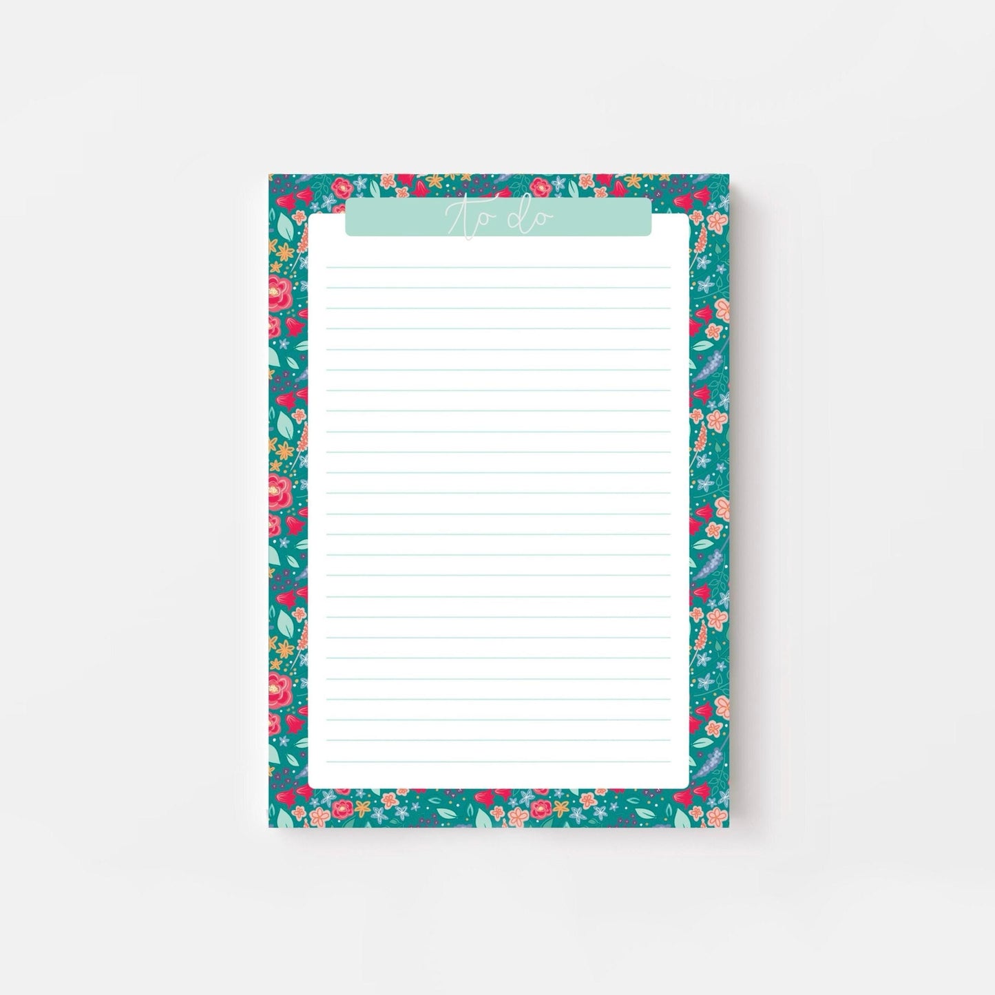 Floral-patterned notepad with a white writing surface on a light gray background
