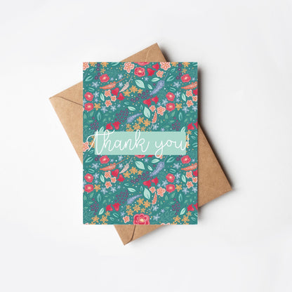 Floral card with 'thank you' text and matching envelope on a white background
