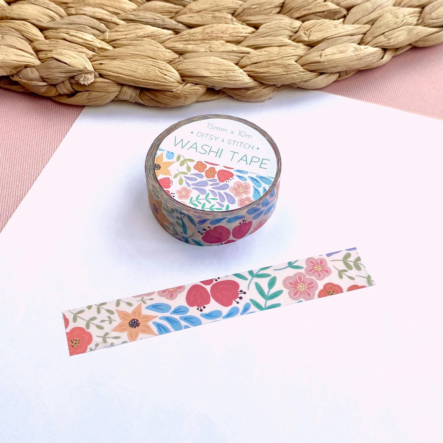 Decorative washi tape with floral design on a white surface
