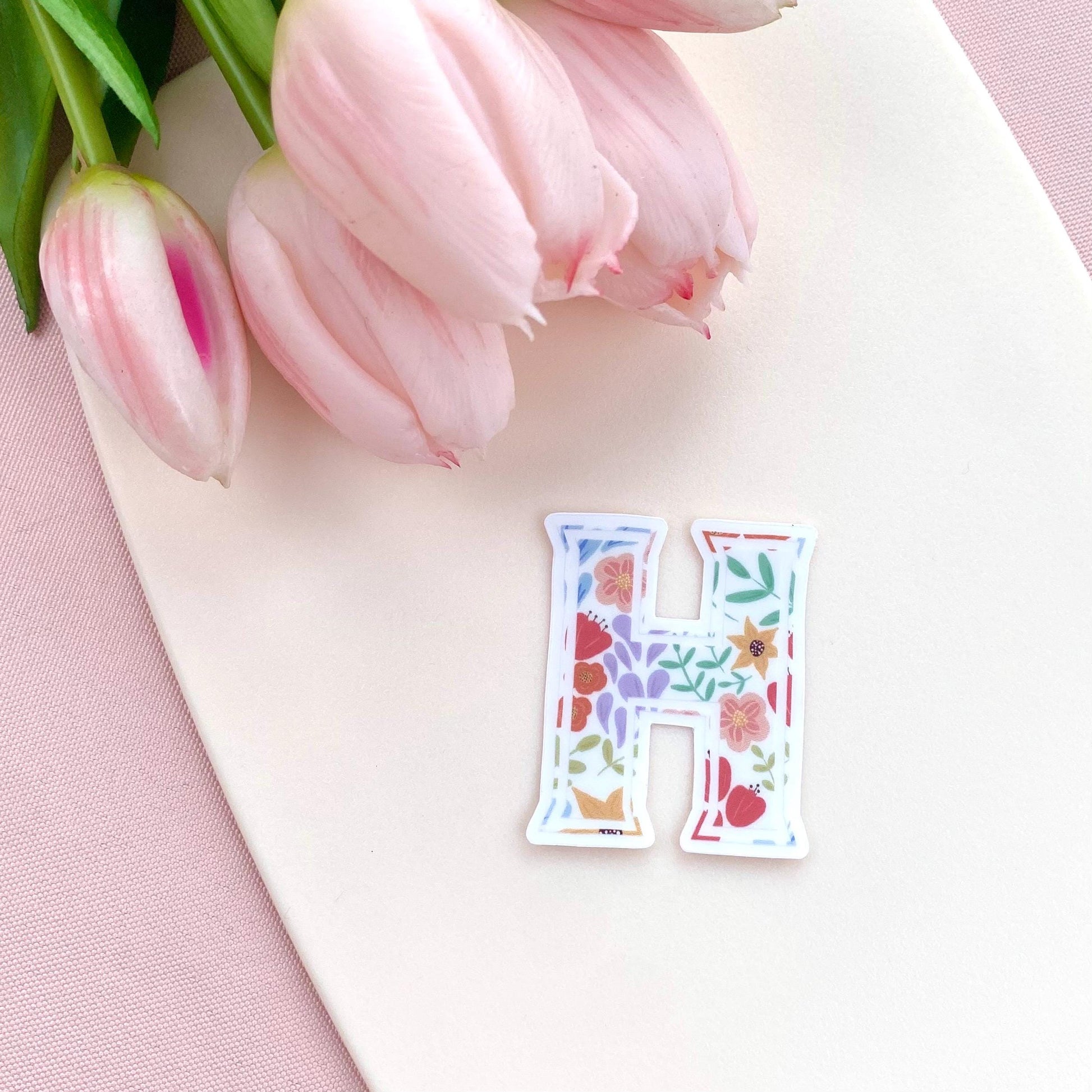 Letter 'H' sticker with floral design on a white background with pink tulips